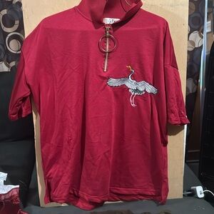 Red shirt with gold circle zipper with bird on it